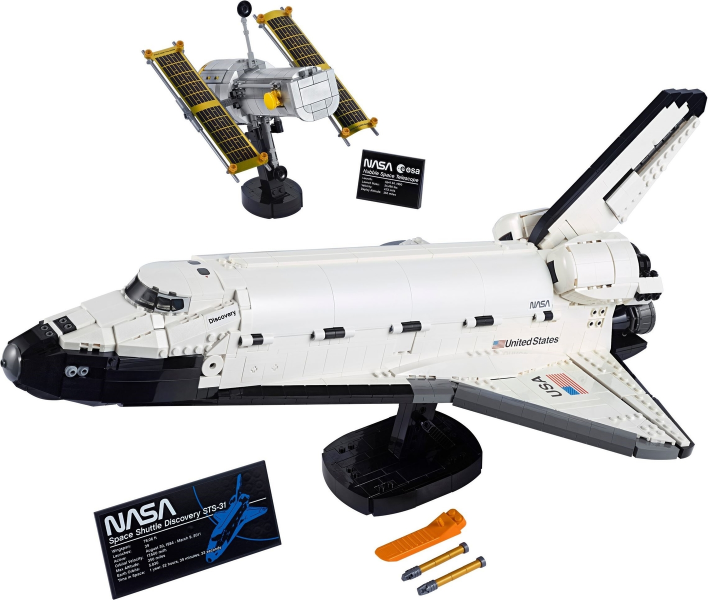 LEGO set 10283 NASA Space Shuttle Discovery from 2021, a large white shuttle orbiter on a stand, with a separate Hubble Space Telescope model with gold solar arrays on its own smaller stand behind it.